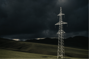 Lone HV Transmission Tower Against Stormy Skies